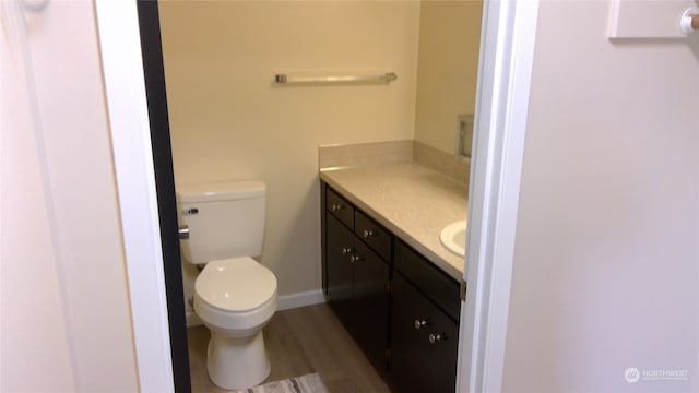 bathroom featuring hardwood / wood-style flooring, vanity, and toilet