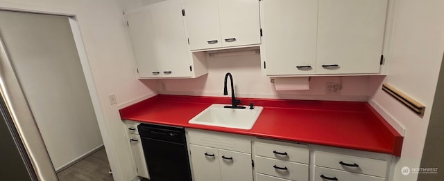 kitchen with white cabinetry, dishwasher, and sink