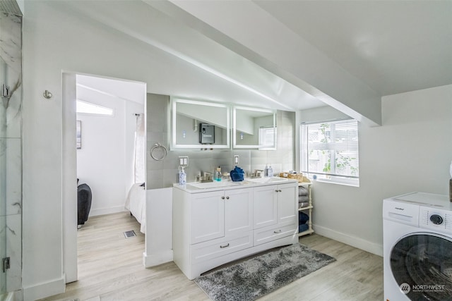 laundry room featuring washer / clothes dryer, light hardwood / wood-style flooring, and sink