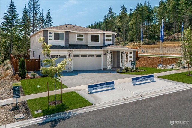 view of front of house featuring a garage and a front lawn