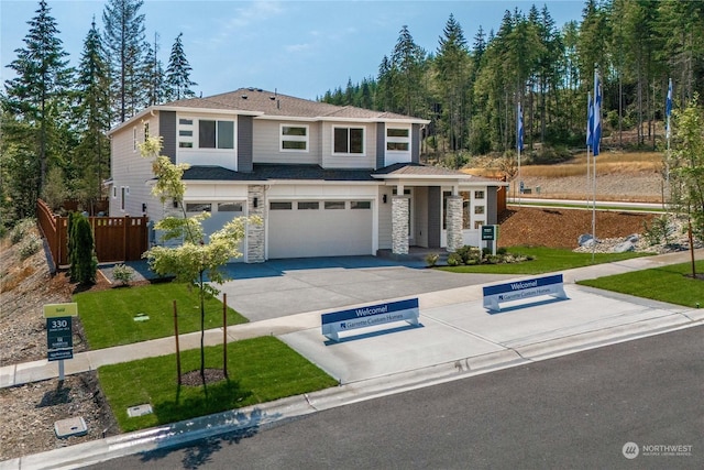 view of front of house with a garage and a front lawn