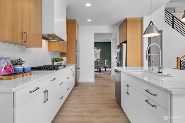 kitchen with custom exhaust hood, sink, pendant lighting, and white cabinets