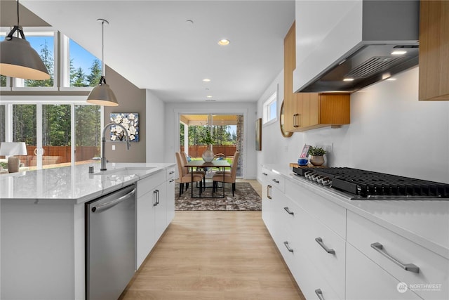 kitchen featuring white cabinetry, pendant lighting, stainless steel appliances, and premium range hood