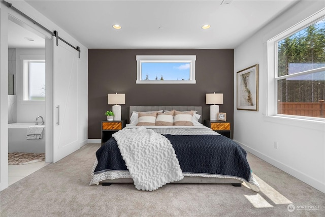 carpeted bedroom with a barn door