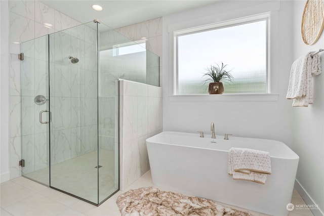 bathroom featuring separate shower and tub