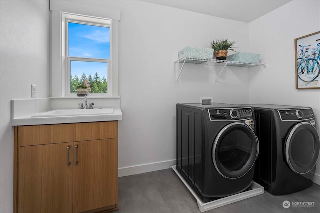 laundry area with cabinets, sink, and washing machine and clothes dryer