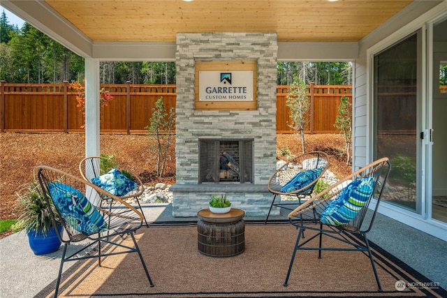 view of patio with an outdoor stone fireplace