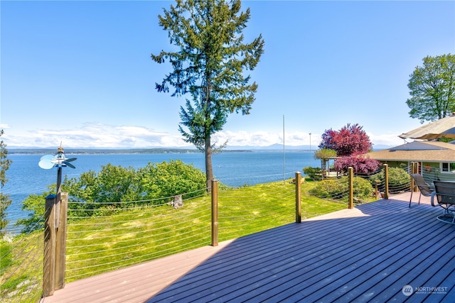 wooden terrace featuring a water view