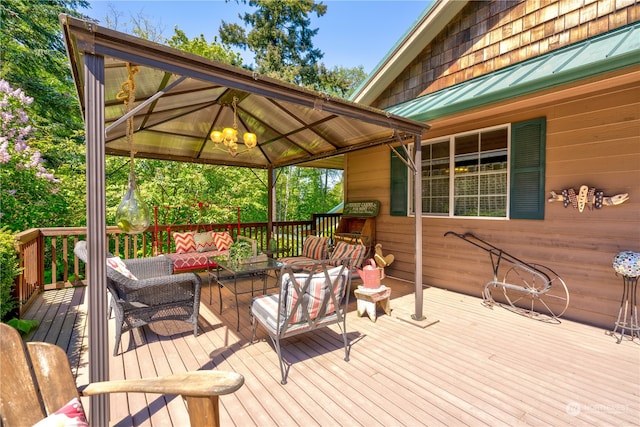 wooden deck with an outdoor living space and a gazebo