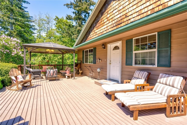 wooden terrace with outdoor lounge area and a gazebo