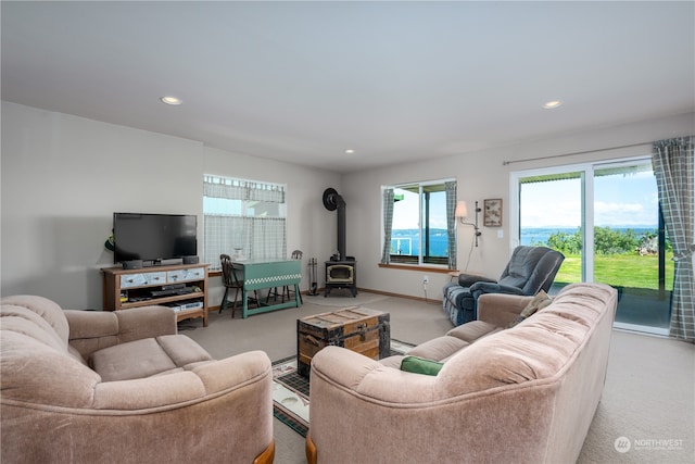 carpeted living room with a wood stove