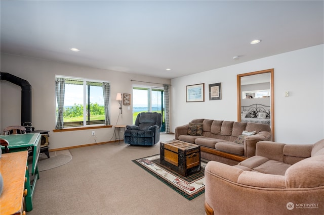 carpeted living room featuring a wood stove