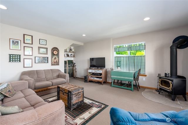 carpeted living room featuring a wood stove