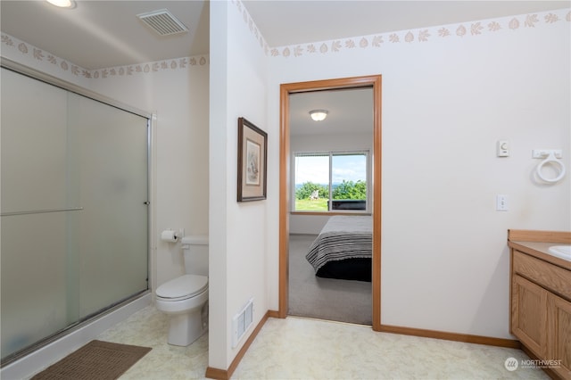 bathroom with an enclosed shower, toilet, tile flooring, and vanity