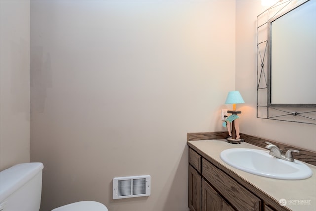 bathroom with toilet and vanity