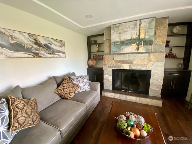 living room featuring a fireplace and dark hardwood / wood-style floors