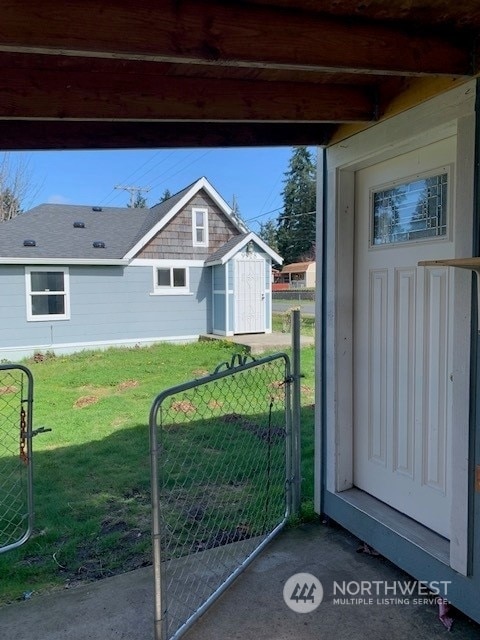 exterior space with a storage unit and a yard