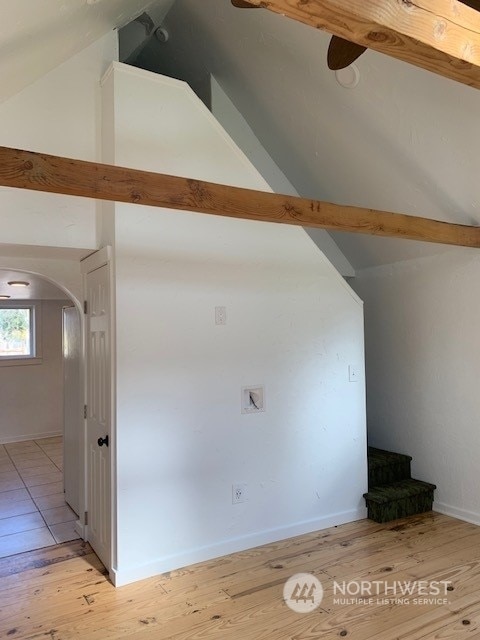 bonus room featuring light hardwood / wood-style flooring and vaulted ceiling