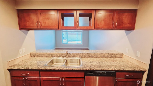 kitchen with light stone counters, sink, and stainless steel dishwasher