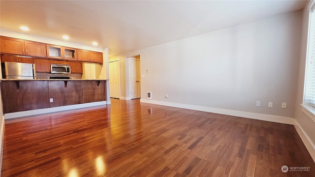 unfurnished living room featuring dark hardwood / wood-style floors