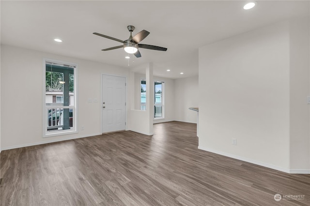 unfurnished living room with hardwood / wood-style flooring and ceiling fan