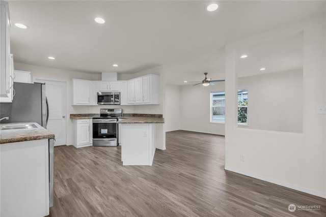 kitchen featuring sink, light hardwood / wood-style flooring, ceiling fan, white cabinetry, and stainless steel appliances