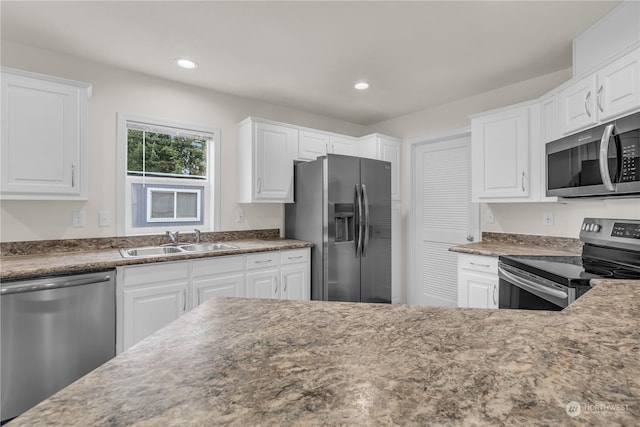 kitchen featuring white cabinetry, appliances with stainless steel finishes, and sink