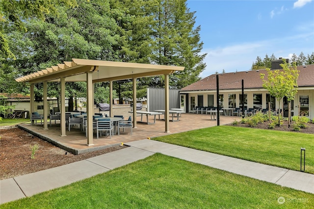 view of property's community with a yard and a patio area