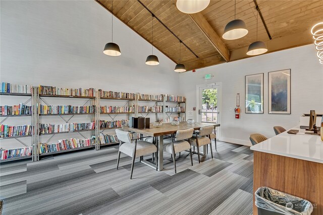 carpeted dining space featuring beamed ceiling, wooden ceiling, and high vaulted ceiling