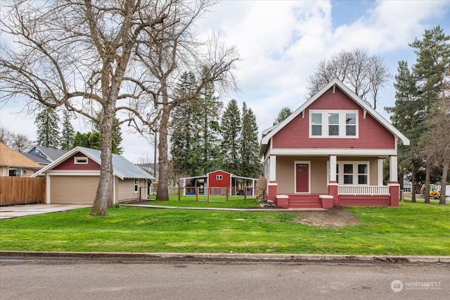 craftsman-style home featuring covered porch, a front lawn, and an outdoor structure