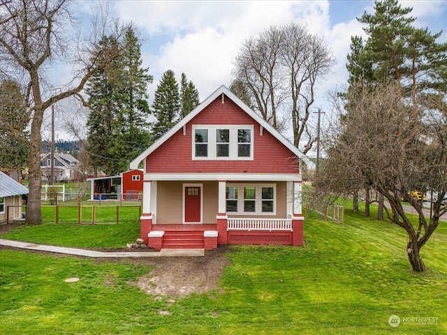 view of front facade with covered porch and a front yard