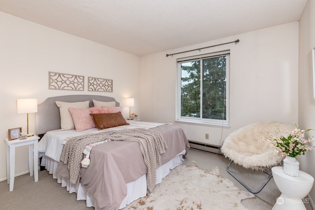 carpeted bedroom featuring a baseboard heating unit and a textured ceiling