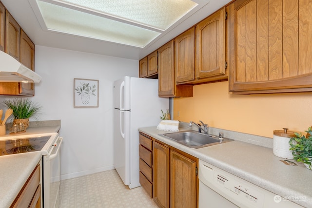 kitchen with sink, white appliances, and light tile floors