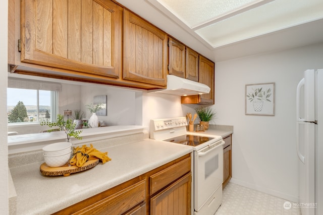 kitchen featuring white appliances and light tile floors