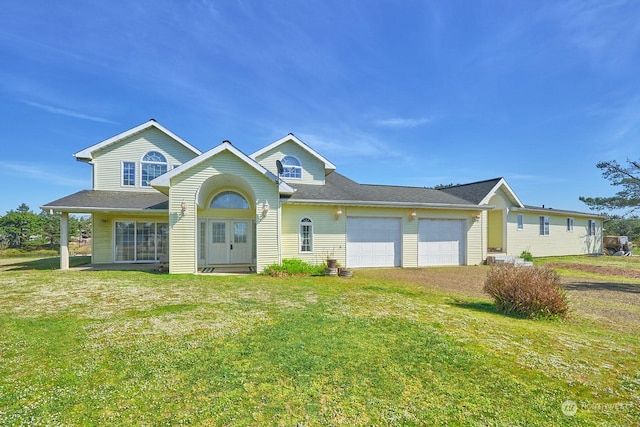 view of front of property with a front lawn and a garage