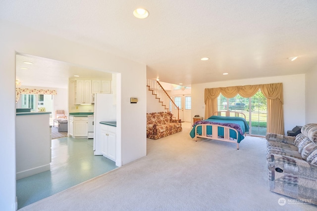 bedroom with a textured ceiling and white fridge