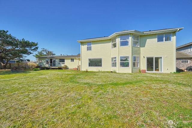 rear view of house featuring a yard