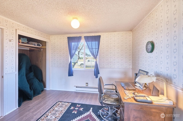 office space with a textured ceiling, dark hardwood / wood-style flooring, and baseboard heating