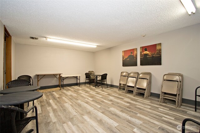 sitting room with a textured ceiling and light hardwood / wood-style flooring