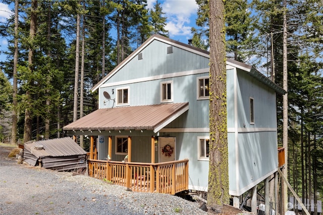 view of front of property featuring metal roof and a porch