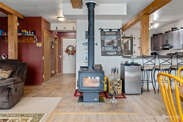 tiled living room with a wood stove