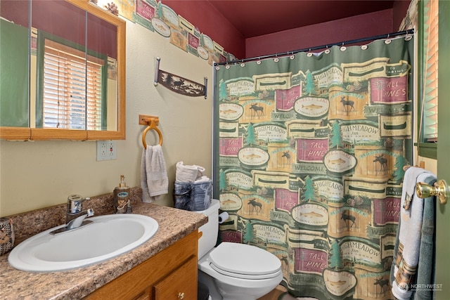 bathroom with large vanity and toilet