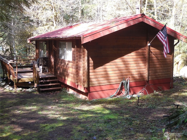 view of side of home featuring a wooden deck