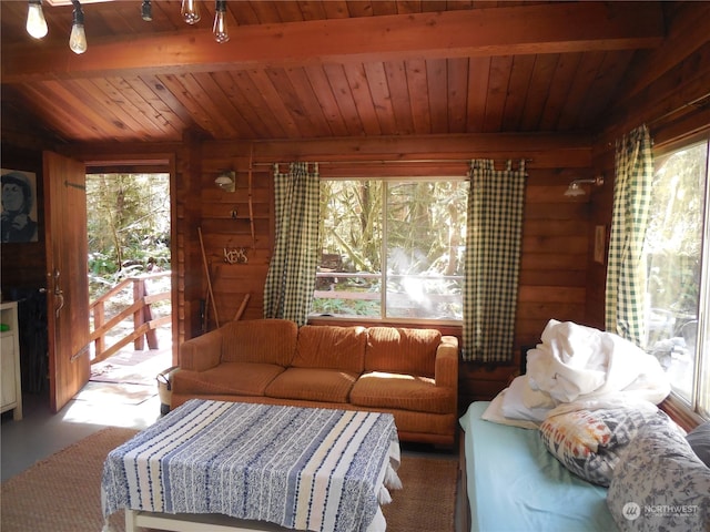 living room featuring beamed ceiling, wooden ceiling, and wooden walls