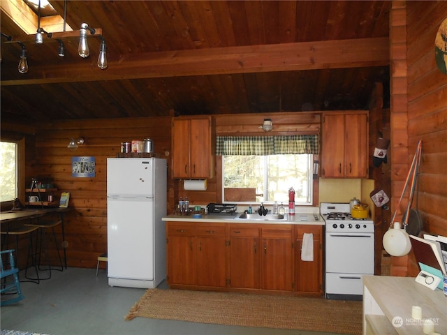 kitchen featuring wood walls, white appliances, beam ceiling, sink, and wood ceiling