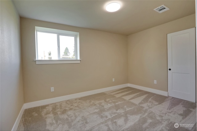 unfurnished room with light carpet