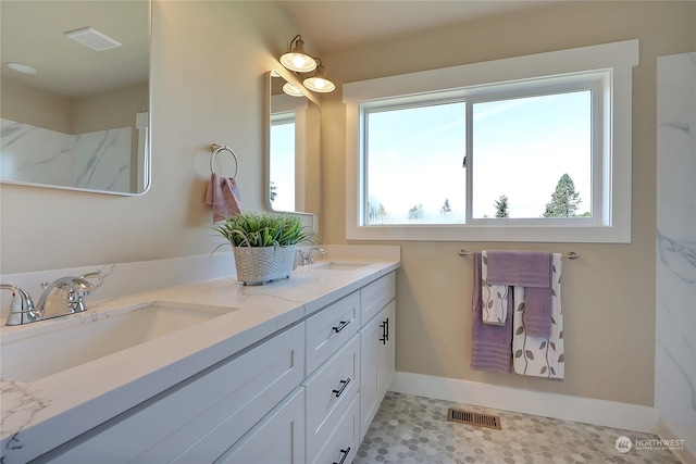 bathroom with tile flooring and double sink vanity