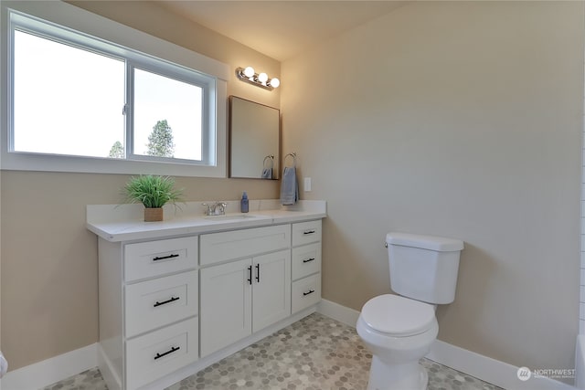 bathroom with vanity, tile floors, and toilet