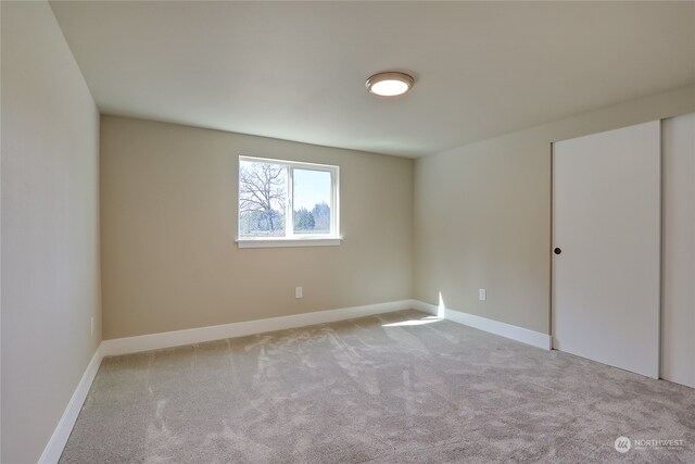 empty room featuring light carpet