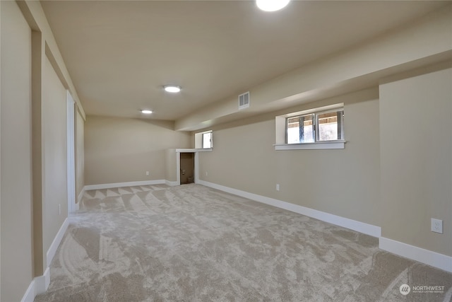 basement featuring light carpet